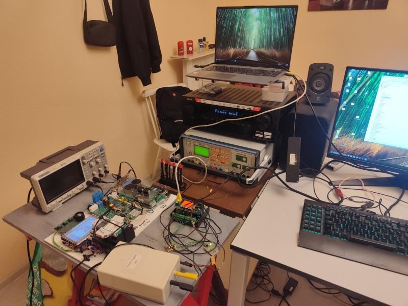 Development workspace with connected hardware, measurement instruments, and computers